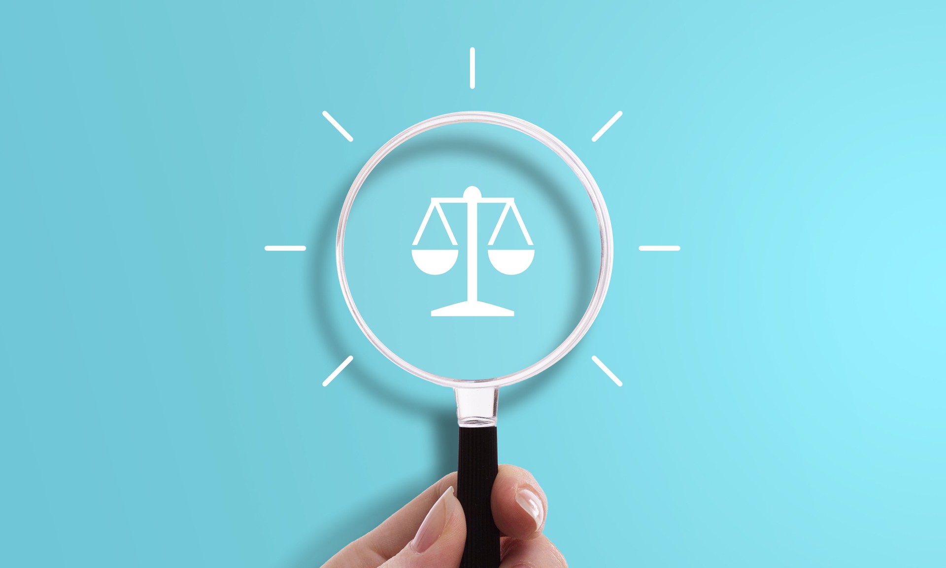 Hand holding magnifying glass with scale icon, symbol of justice, law, and legal system